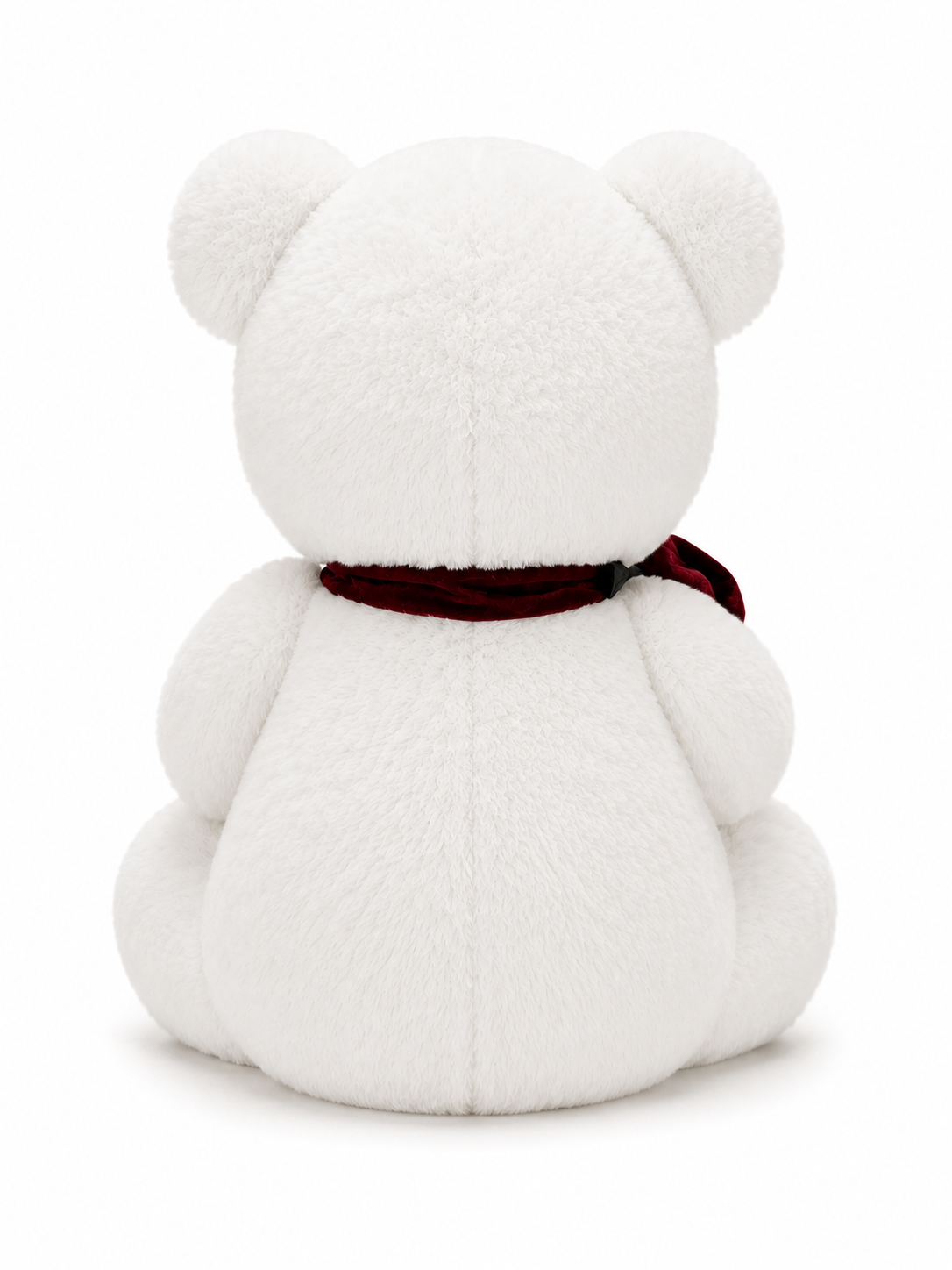 White teddy bear plush holding a red rose with a black bow, romantic soft toy gift